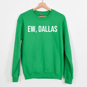 May include: Green sweatshirt with white text that reads "EW, DALLAS".