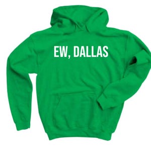 May include: Green hooded sweatshirt with the text "EW, DALLAS" in white.