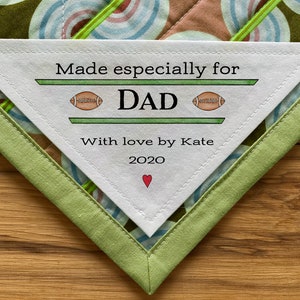 May include: White fabric label with green stitching, reading "Made especially for DAD" with football illustrations and "With love by Kate 2020" and a red heart.