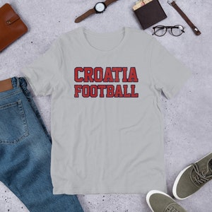 May include: A gray t-shirt with the text "CROATIA FOOTBALL" in red and blue letters.