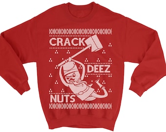 May include: Red Christmas sweater with a white design of a person holding a pickaxe and the text "Crack Deez Nuts".
