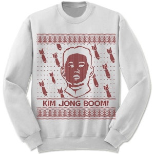 May include: White Christmas sweater with a red knitted design featuring a portrait of Kim Jong-un and the text "KIM JONG BOOM!"