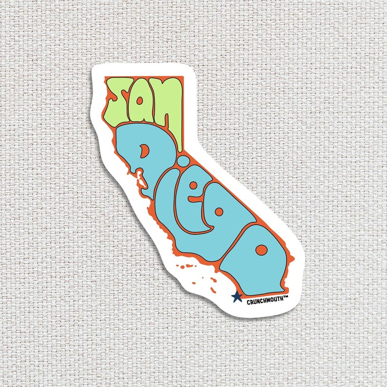 san diego travel luggage sticker, hand display, white textured fabric background