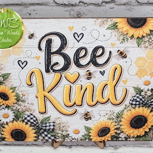 May include: A square wooden sign with a white wood-plank background featuring the text Bee Kind in black and yellow script. The design includes yellow sunflowers, white daisies, small bees, black and white gingham bows, and hearts.
