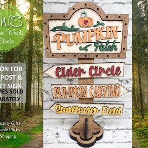 May include: Wooden sign with a pumpkin patch theme. The sign has a large top sign that says "Pumpkin Patch" and three smaller signs that say "Cider Circle", "Pumpkin Carving", and "Sunflower Field".