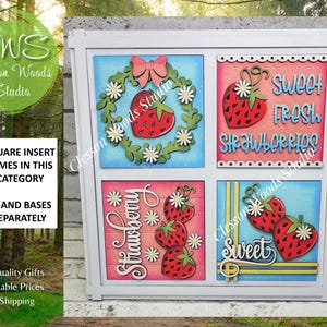 May include: A white square frame containing four 4.25-inch square inserts featuring strawberry themes. The top left shows a strawberry wreath with a pink bow, top right says SWEET FRESH STRAWBERRIES, bottom left says STRAWBERRY, and bottom right says SWEET.