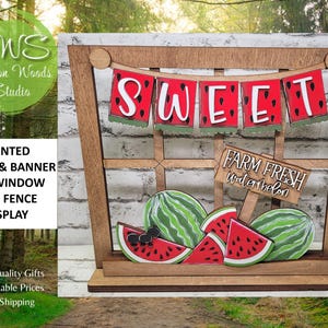 May include: A wooden window frame display featuring a banner with the word SWEET in red watermelon-themed letters. Below, a sign reads FARM FRESH watermelon, accompanied by several painted wooden watermelon slices and whole melons.