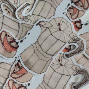 May include: A set of beige and brown stickers featuring a stylized illustration of a teapot with a lid and a handle. The teapot is surrounded by a swirling design and has a cup with a handle and a saucer.