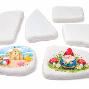 May include: A collection of decorative white stones. Two stones feature painted scenes: a beach with a sandcastle and a gnome with mushrooms. The other stones are plain. Ideal for garden decor or crafts.