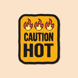 May include: A yellow sticker with a black border and the text "CAUTION HOT" in black. Three red and orange flames are above the text.