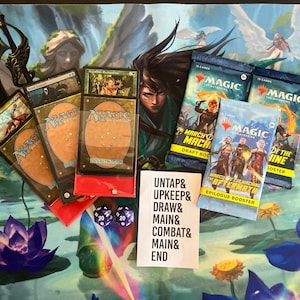 May include: A collection of Magic: The Gathering cards and booster packs, including a red deck box, two blue draft booster packs, and a yellow booster pack. The booster packs are for the March of the Machine set. The text on the booster packs reads "March of the Machine: The Aftermath Epilogue Booster". There are also two blue 20-sided dice and a white card with the text "UNTAP& UPKEEP& DRAW& MAIN& COMBAT& MAIN& END".