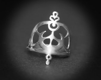 May include: A silver ring with a delicate, intricate design featuring a floral motif. The ring is open and has a cutout design, creating a unique and stylish look.