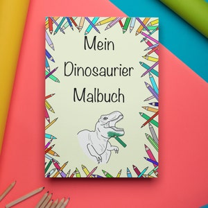 May include: A coloring book titled "Mein Dinosaurier Malbuch" with a dinosaur illustration. The cover is surrounded by a border of colorful pencils. The background is a mix of pink, blue, yellow, and green.