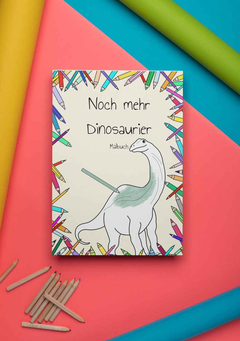 May include: A colouring book with a colourful border of pencils. The cover features a cartoon dinosaur with the title "Noch mehr Dinosaurier" and the word "Malbuch".
