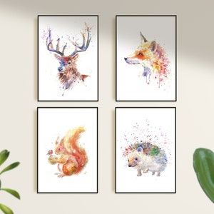May include: Four framed watercolor prints featuring forest animals. The prints depict a deer, fox, squirrel, and hedgehog, each rendered in a vibrant, splattered paint style with a white background. The frames are black.
