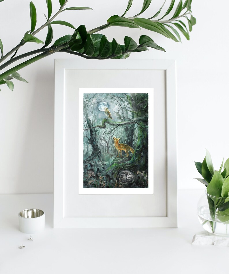 May include: Watercolor art print of a forest scene with a howling fox under a full moon. An owl perches on a branch, and a sleeping badger rests below. The artwork is framed in a white border.