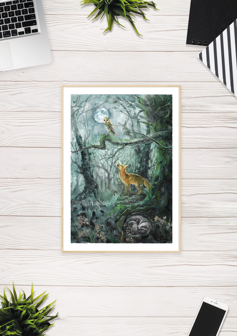 May include: Watercolor print of a moonlit forest scene. An owl perches on a branch, a fox howls at the moon, and a sleeping animal rests in a hollow. The artwork is framed in a light wood frame.