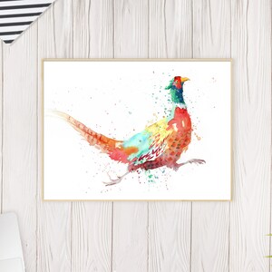 May include: Watercolor painting of a pheasant in vibrant colors. The bird is depicted in motion with a long tail and detailed plumage. The artwork is framed and set against a white background, suitable for home decor.
