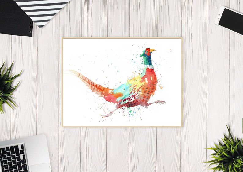 May include: Watercolor painting of a pheasant in vibrant colors. The bird is depicted in motion with a long tail and detailed plumage. The artwork is framed and set against a white background, suitable for home decor.