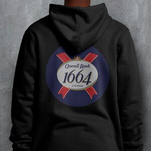 May include: Black hoodie with a circular emblem on the back. The emblem has the text "Overall Rank 1664" in white, with red and blue details. The hoodie is made of a soft fabric.