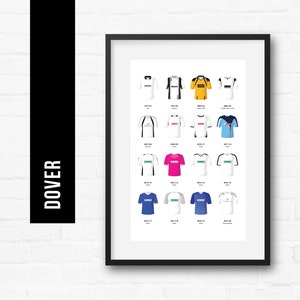 May include: Framed print featuring a collection of Dover Football Club jerseys. The jerseys are displayed in a grid, showcasing various designs and colors, including white, blue, yellow, and pink. The word "DOVER" is printed vertically in white on a black background.