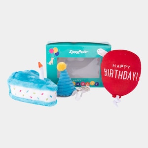 May include: A birthday party set for dogs, featuring a blue cake, a blue party hat, and a red balloon that says "Happy Birthday!"