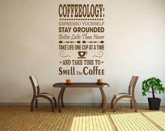 May include: Brown wall decal with the text "COFFEEOLOGY: ESPRESSO YOURSELF STAY GROUNDED Better Latte Than Never TAKE LIFE ONE CUP AT A TIME • AND TAKE TIME TO - SMELL The Coffee"