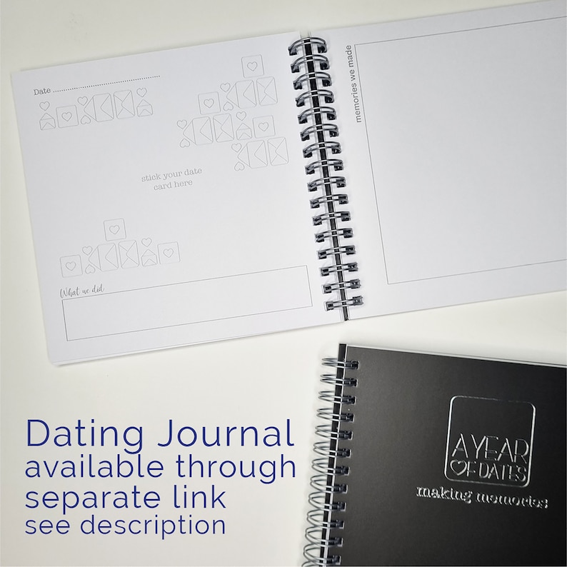 May include: A black and white journal with the text "A Year of Dates" and "Making Memories" on the cover. The journal is open to a page with a date section, a place to stick a date card, and a section to write about what you did on the date. The journal is spiral bound.