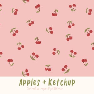 Op de afbeelding: Een naadloos herhalend patroon van rode kersen met groene stelen en bladeren op een lichtroze achtergrond. De tekst "Apples + Ketchup" staat onderaan de afbeelding.