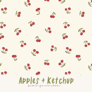 Op de afbeelding: Een crèmekleurige achtergrond is bedekt met een patroon van rode kersen met groene stelen en bladeren. De tekst "Apples + Ketchup" is groen geschreven, met "Kid's favorites" eronder in een scriptlettertype.
