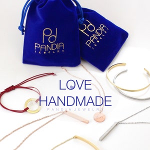 May include: A collection of handmade jewelry pieces, including necklaces, bracelets, and a bangle. The jewelry is made of gold, silver, and red string. The jewelry is displayed on a white background with two blue velvet bags with the text "PD PANDIA JEWELRY" printed on them. The text "LOVE HANDMADE PANDIA JEWELRY" is displayed in the center of the image.