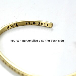 May include: A gold-toned metal bracelet with an inscription that reads "R &hearts; L 21. 8. 2017".