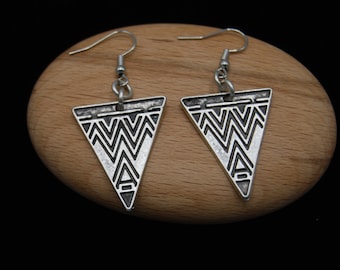 May include: A pair of silver triangle earrings with a geometric pattern. The earrings have a hook closure.