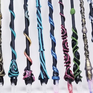 May include: A collection of 16 handmade wands with various colors and designs. Each wand has a unique crystal tip and is made with polymer clay.