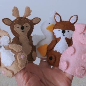 May include: Five felt finger puppets: a brown rabbit, a brown deer, a white goose with an orange beak, a brown fox, and a pink pig.
