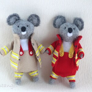 In this picture: two handmade felt koala bears, both dressed as a firefighter, one in a red costume, the other in a sand-colored costume. all clothing has refelcting stripes in yellow and silver.  All is made with a PDF handsewing pattern from WoolFeltWonders, part of a series with toy animal and clothing patterns to mix and match, to portray hobby or profession for play.
