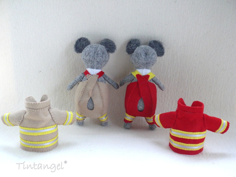 In this picture: two handmade felt koala bears, both dressed as a firefighter, one in a red costume, the other in a sand-colored costume. all clothing has refelcting stripes in yellow and silver. All is made with a PDF handsewing pattern from WoolFeltWonders, part of a series with toy animal and clothing patterns to mix and match, to portray hobby or profession for play.