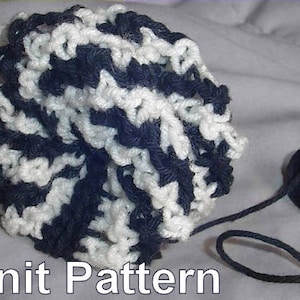 May include: A close-up of a black and white crocheted ball with a length of black yarn. Knit Pattern is written below the ball.