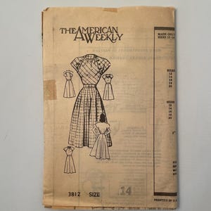 May include: Vintage sewing pattern from The American Weekly. The pattern features a dress design with a fitted bodice and a pleated skirt. The size is 14. The pattern is printed in the U.S.A. and includes sizes 12-14.