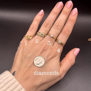 May include: Four gold rings with diamond accents are displayed on a hand, next to a dime. The rings are numbered 1 through 4. The word "diamonds" is written below the dime.