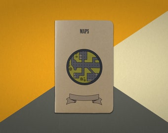 May include: A brown notebook with the word "MAPS" printed on the front cover. The notebook has a circular design with a map inside and a ribbon banner.