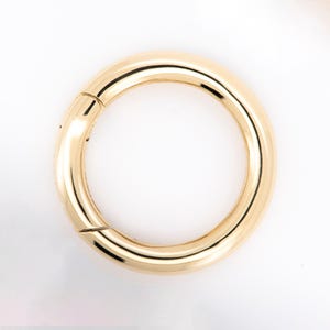 May include: A set of three ceramic mugs with a speckled, matte finish in cream, light grey, and dark grey. Each mug has a simple, minimalist design, suitable for coffee or tea.