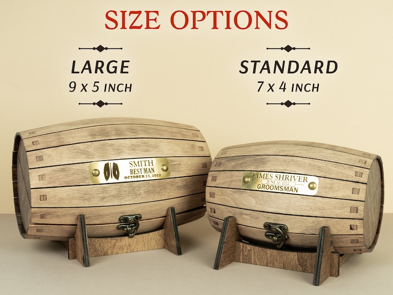May include: Two wooden barrel-shaped boxes with lids and brass catches. The boxes are on stands and have personalised brass plaques. The larger box is 9 x 5 inches and the smaller box is 7 x 4 inches.