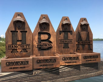 May include: Four wooden bottle openers with personalised names and the word "Groomsman" and the date "18 June 2019".