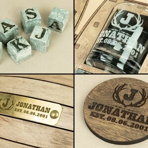 May include: A wooden box containing a glass whiskey tumbler, a coaster, and a set of whiskey stones. The box is engraved with the name "Jonathan" and the date "EST. 08.06.2001".
