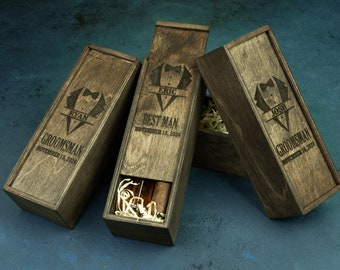 May include: Three wooden boxes with engraved text and a tuxedo graphic. The boxes are labeled "Best Man", "Groomsman", and "Groomsman" with the names "Eric", "Ryan", and "Josh" and the date "November 16, 2024".