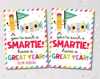 May include: Two colourful cards with a rainbow border. Each card features a cartoon pencil and candy with the text "You're such a SMARTIE! Have a GREAT YEAR!" and "FROM: DANISHA."