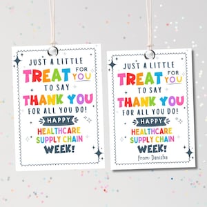 May include: Two white gift tags with the text "Just a little treat for you to say thank you for all you do! Happy Healthcare Supply Chain Week!" in colorful letters. The tags have a decorative border and are strung with white string.