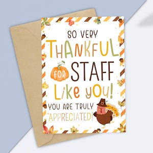 May include: A Thanksgiving-themed greeting card with a brown envelope. The card features the text "So Very Thankful for Staff Like You!" with a pumpkin illustration and a cartoon turkey wearing a pilgrim hat. The card is decorated with autumn leaves.
