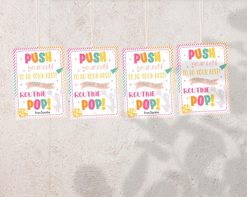 May include: Four colorful signs with the text "PUSH yourself TO DO YOUR BEST! MAKE THAT ROUTINE POP!" with a cheerleader silhouette and the text "From Danisha" at the bottom.